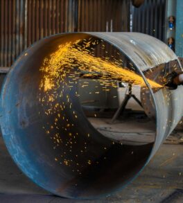 man wearing yellow hard hat holding angle grinder